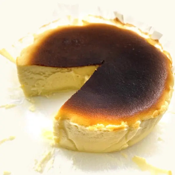 Wasabi Burnt Cheesecake with a wedge cut out, pale creamy inside