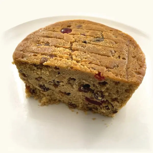 The Alcoholic Fruit Cake cut open, dense with raisins and cherries