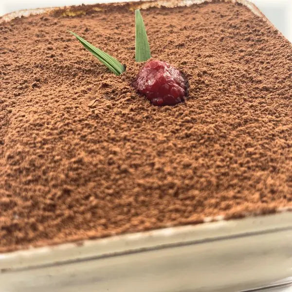 Close-up of the cocoa-dusted top and the raspberry