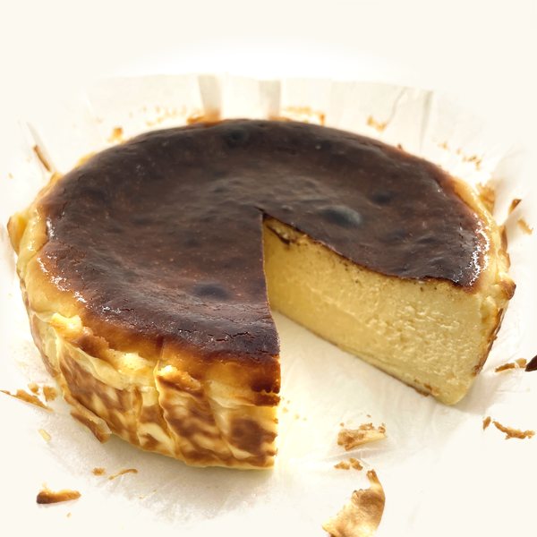 Molten Burnt Cheesecake with a wedge cut out, soft golden inside