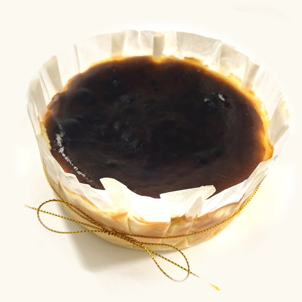 Whole Wasabi Burnt Cheesecake in fluted parchment with gold string