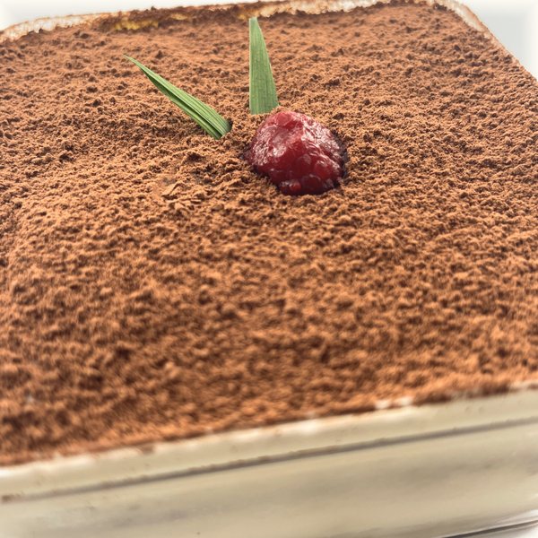 Close-up of the cocoa-dusted top and the raspberry